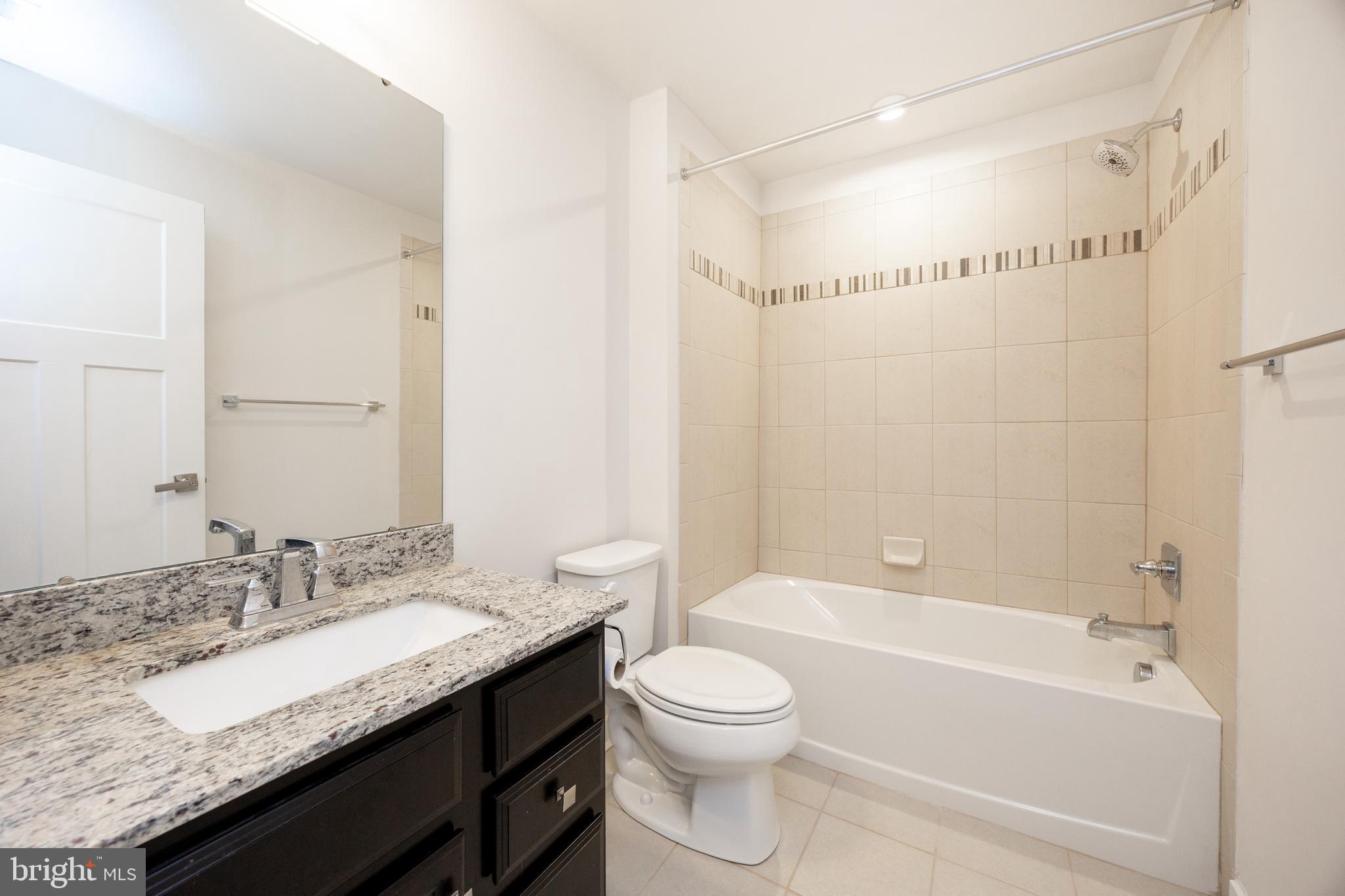 131 Mulberry Drive Malvern, PA 19355 - Photo 24 of 37 a bathroom with a granite countertop sink a toilet a mirror and shower