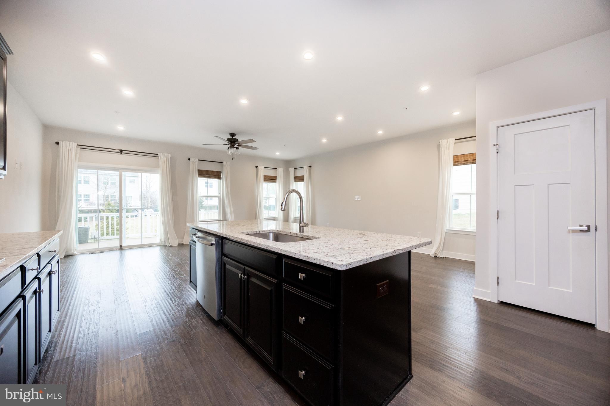 131 Mulberry Drive Malvern, PA 19355 - Photo 7 of 37 a kitchen with a center island wooden floor appliances and a window