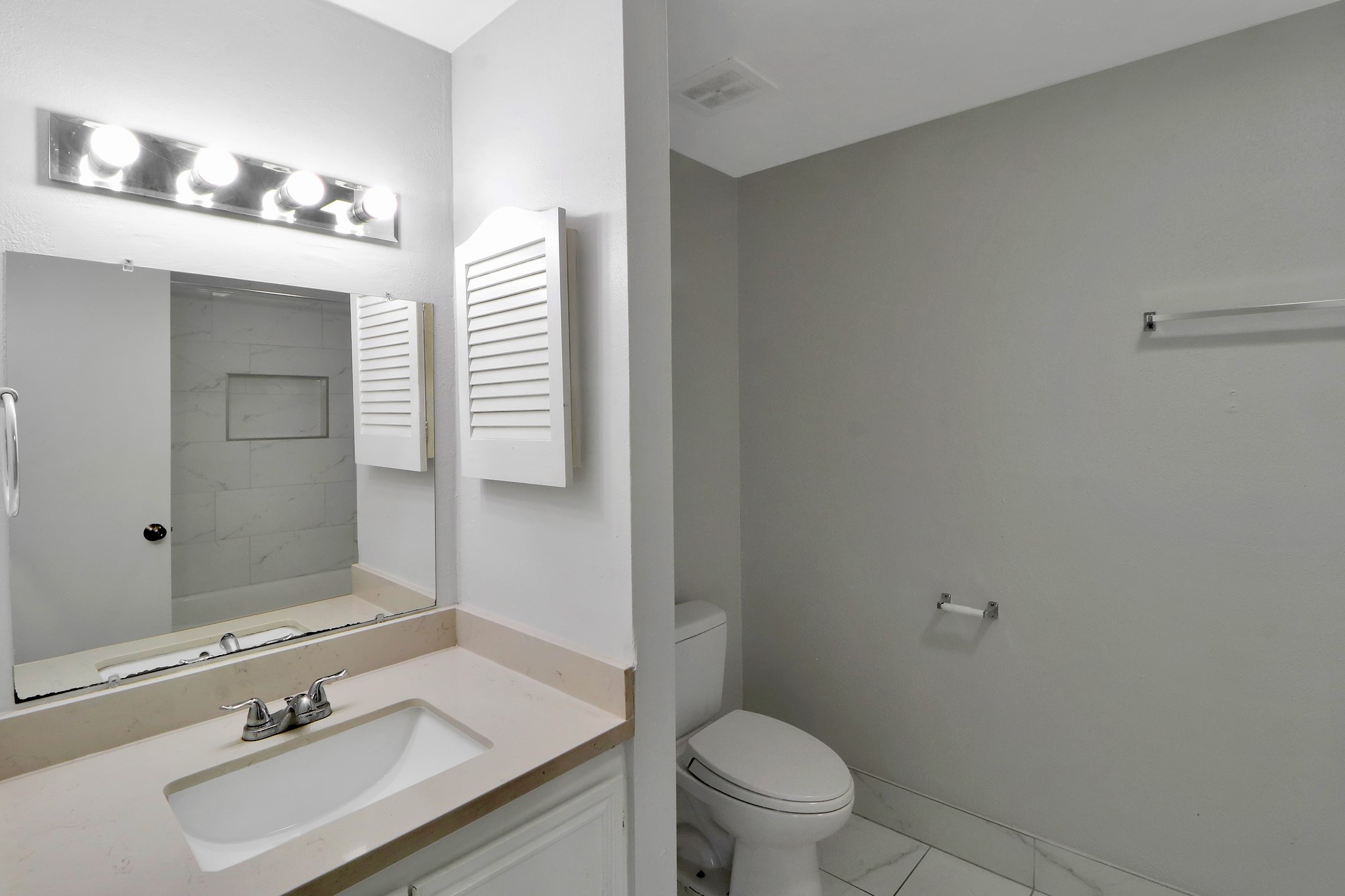 7047 Bissonnet Street, Unit 117 Houston, TX 77074 - Photo 13 of 17 a bathroom with a sink vanity mirror and toilet
