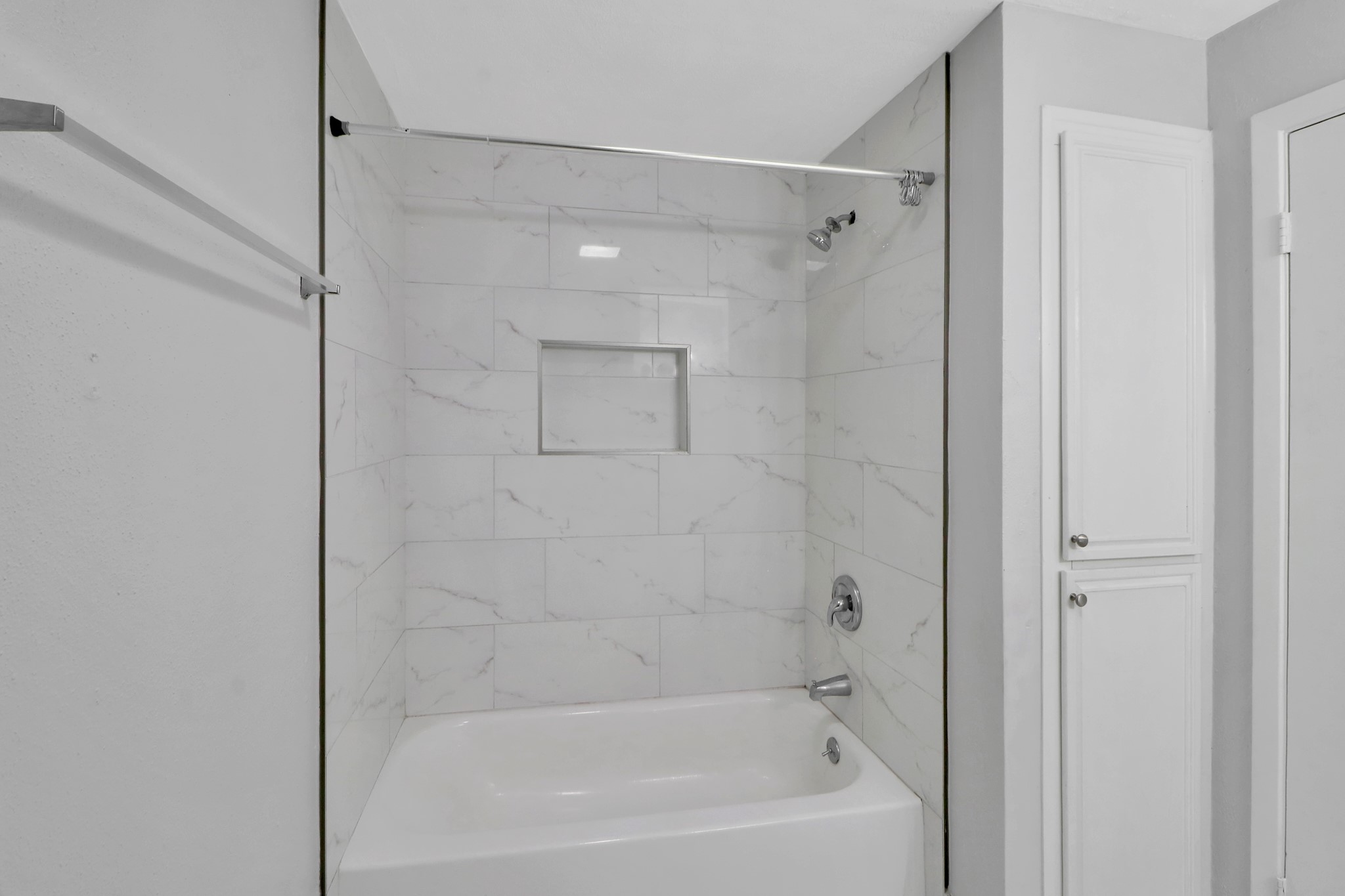 7047 Bissonnet Street, Unit 117 Houston, TX 77074 - Photo 14 of 17 a bathroom with a shower and a bath tub