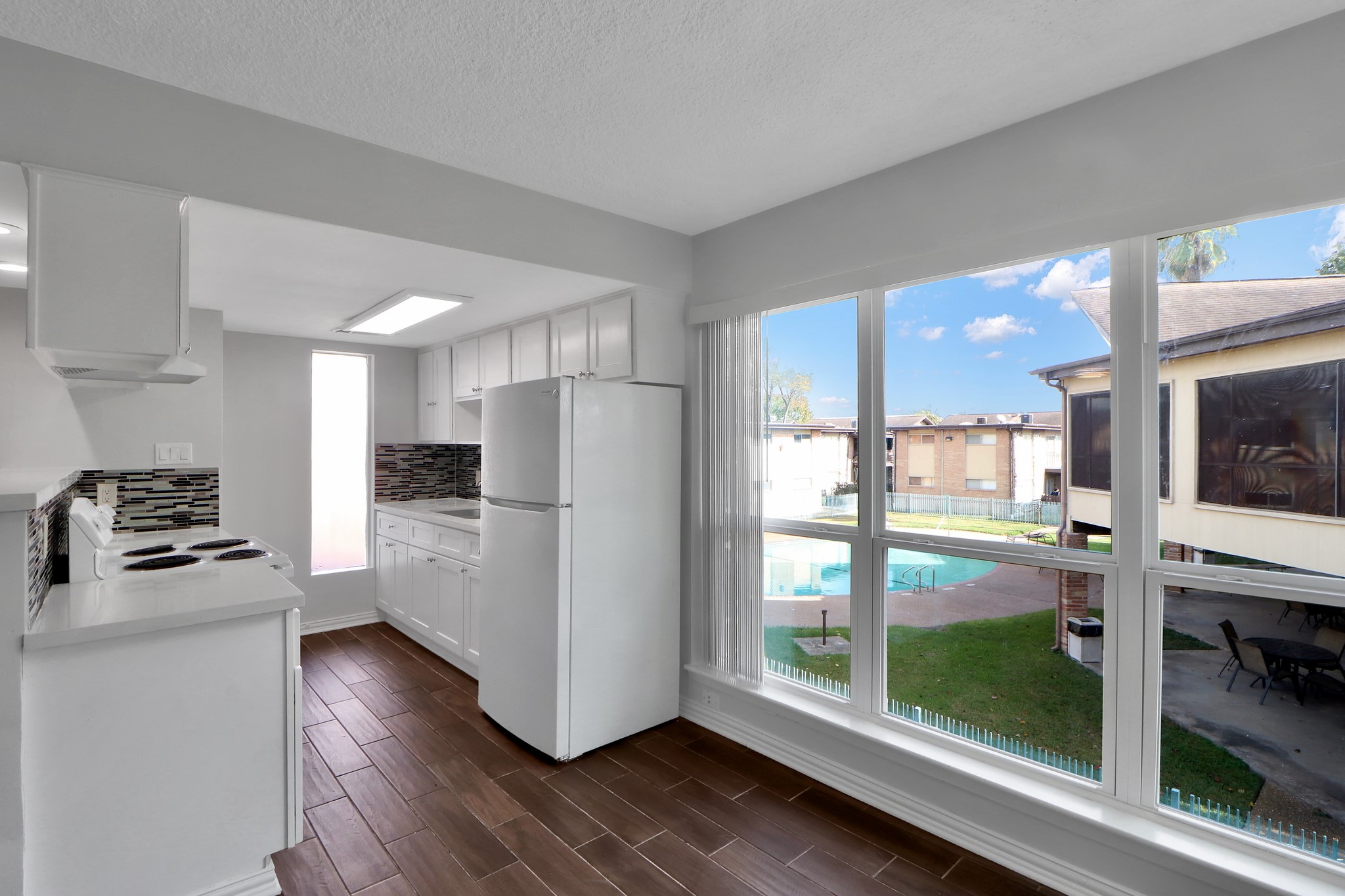 7047 Bissonnet Street, Unit 117 Houston, TX 77074 - Photo 5 of 17 a kitchen with stainless steel appliances a refrigerator and stove
