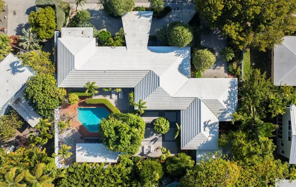 an aerial view of a house with a yard and garden