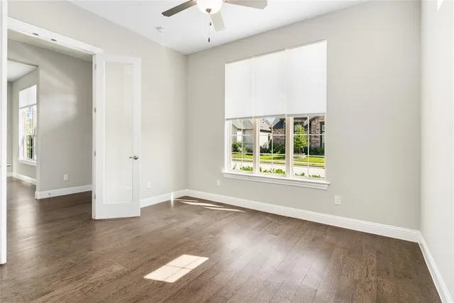 a kitchen with stainless steel appliances granite countertop a sink a oven and a fireplace with wooden floor