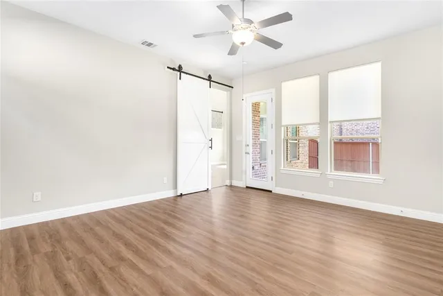 a view of a kitchen with wooden floor and stainless steel appliances