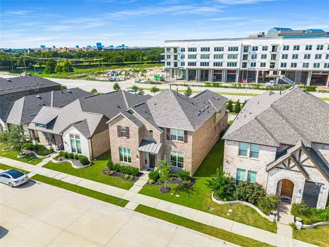 an aerial view of a house with a big yard and large trees