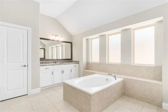 a view of a room with wooden floor and a white door