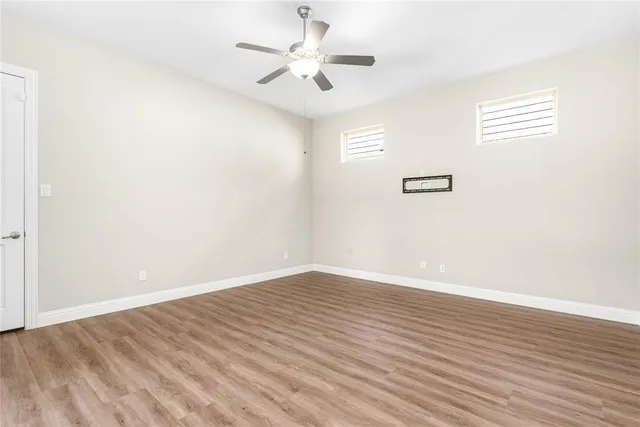 a spacious bathroom with a granite countertop sink mirror and shower