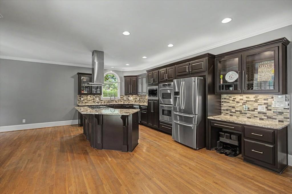 122 Ridge View Drive Ball Ground, GA 30107 - Photo 22 of 84 a kitchen with stainless steel appliances kitchen island wooden cabinets and granite counter tops