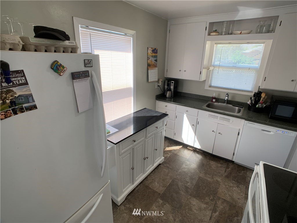 133 Columbia Road Ephrata, WA 98823 - Photo 23 of 29 a kitchen with stainless steel appliances a refrigerator sink and white cabinets