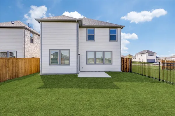 a view of an house with backyard space and balcony