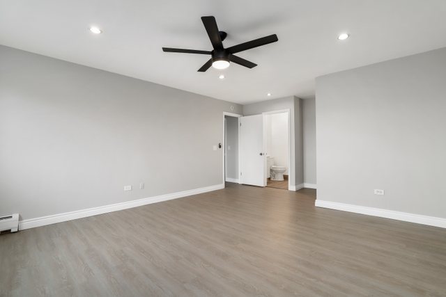 4700 Old Orchard Road, Unit 403 Skokie, IL 60076 - Photo 17 of 21 an empty room with wooden floor and ceiling fan