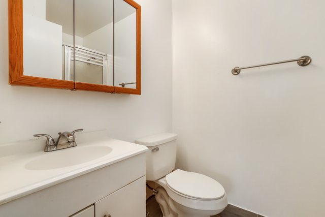 4700 Old Orchard Road, Unit 403 Skokie, IL 60076 - Photo 19 of 21 a bathroom with a sink a toilet and mirror