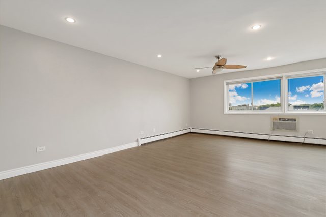 4700 Old Orchard Road, Unit 403 Skokie, IL 60076 - Photo 3 of 21 a view of an empty room with a window and wooden floor