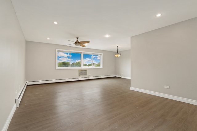 4700 Old Orchard Road, Unit 403 Skokie, IL 60076 - Photo 4 of 21 an empty room with wooden floor and windows