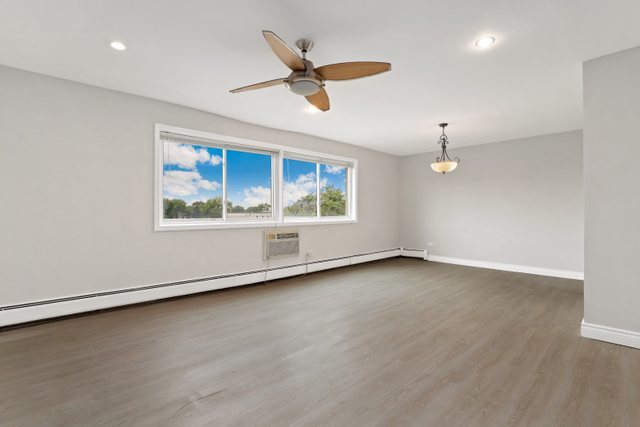 4700 Old Orchard Road, Unit 403 Skokie, IL 60076 - Photo 6 of 21 an empty room with wooden floor ceiling fan and windows