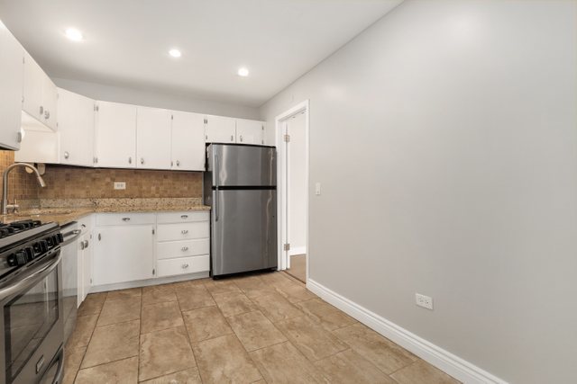 4700 Old Orchard Road, Unit 403 Skokie, IL 60076 - Photo 7 of 21 a kitchen with a refrigerator sink stove and cabinets