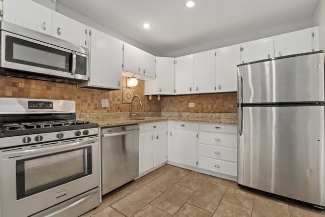 4700 Old Orchard Road, Unit 403 Skokie, IL 60076 - Photo 8 of 21 a kitchen with cabinets stainless steel appliances and wooden cabinets