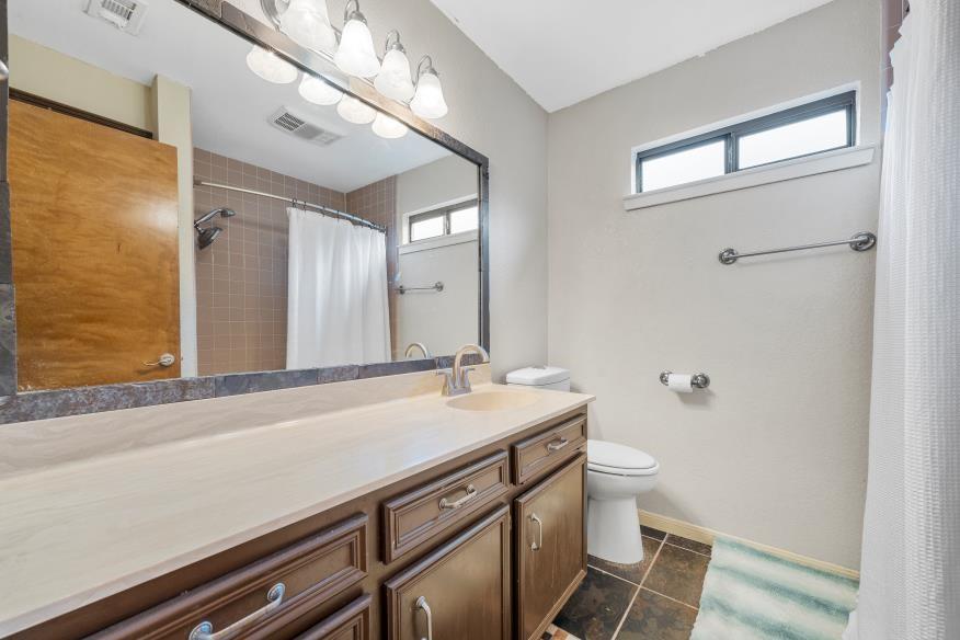 827 Fort Gates Waco, TX 76708 - Photo 16 of 25 a bathroom with a sink a toilet and a mirror