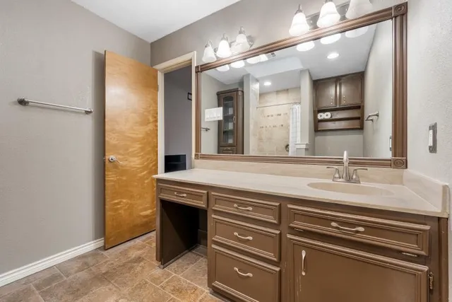a bathroom with a sink a vanity and a mirror