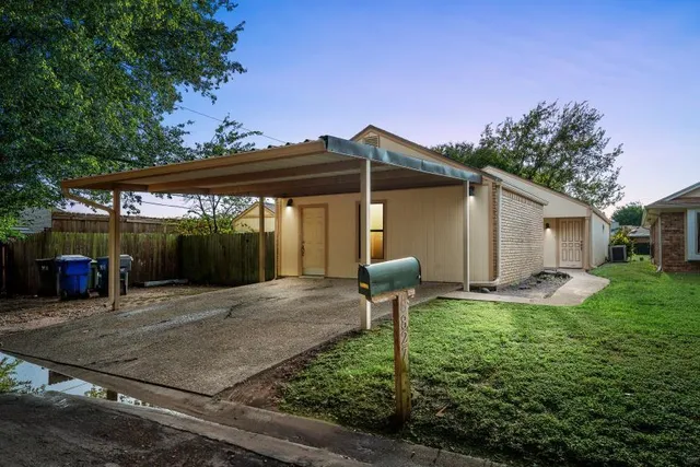 a backyard of a house with yard table and chairs