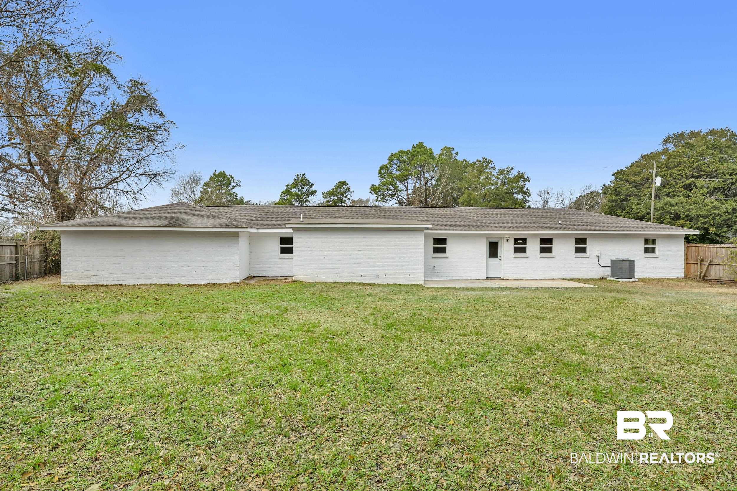 11381 Normandy Drive East Semmes, AL 36575 - Photo 20 of 23 Back of house featuring brick siding, a patio area, and a shingled roof