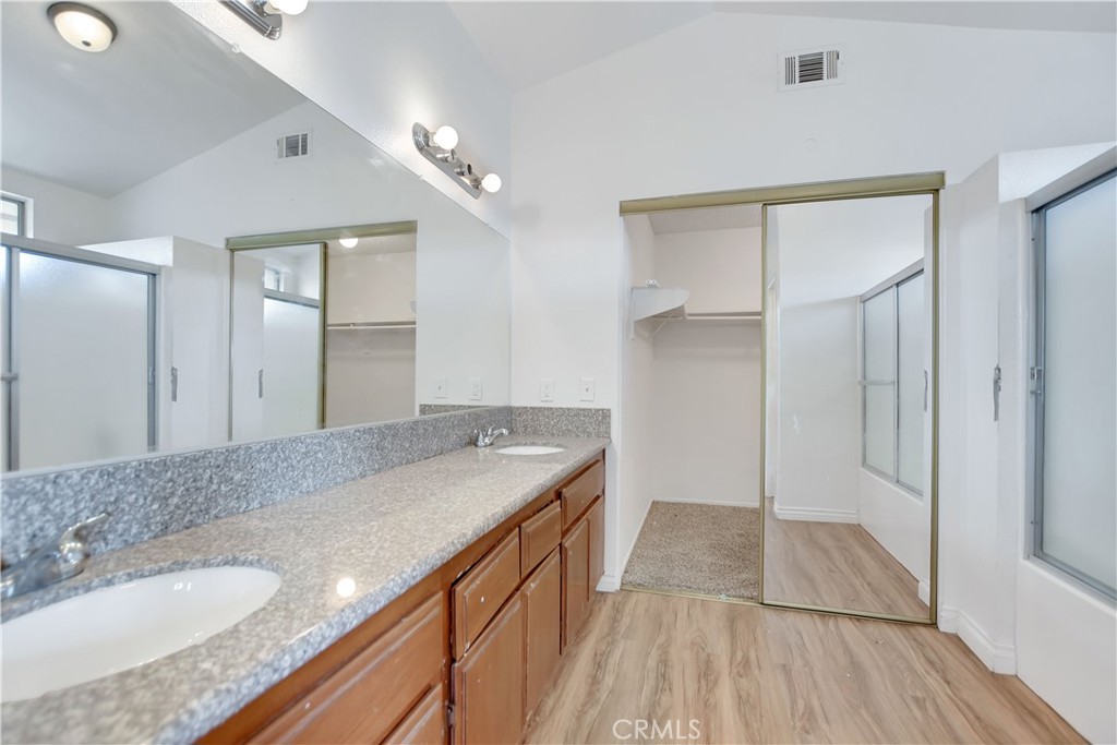 14527 Pony Trail Road Victorville, CA 92392 - Photo 9 of 21 a bathroom with a granite countertop double vanity sink and mirror