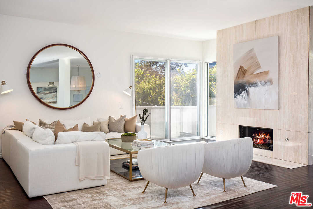 a living room with furniture and a mirror