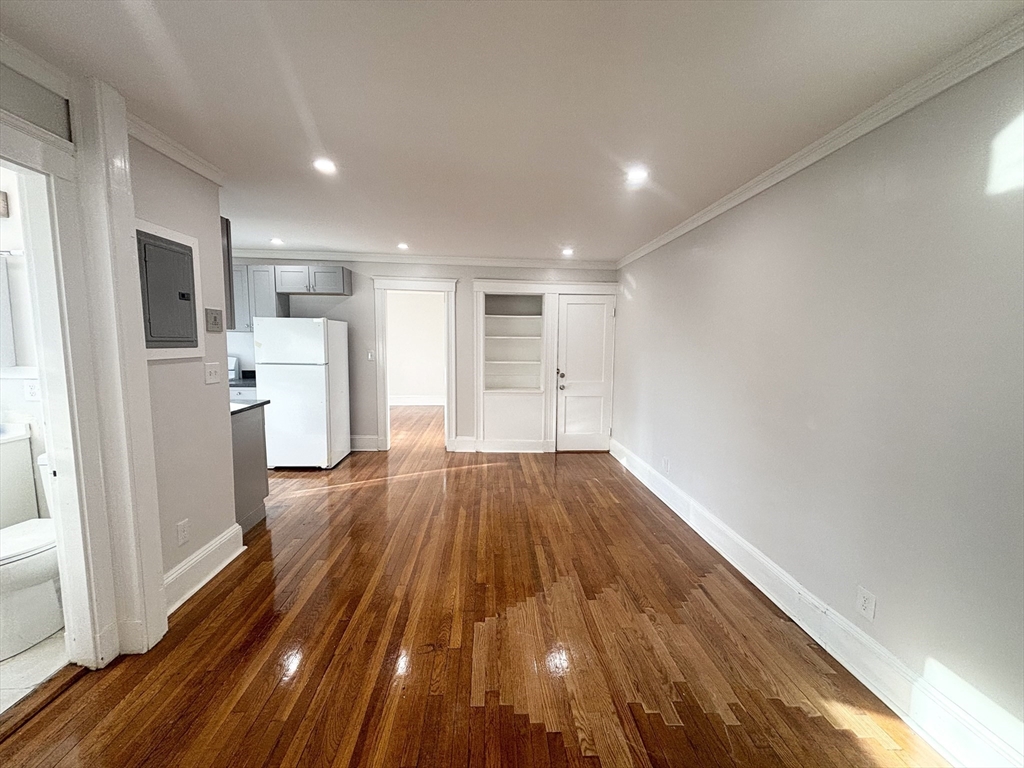 36 Spring Street, Unit 11 Malden, MA 02148 - Photo 4 of 12 a view of empty room with wooden floor and window