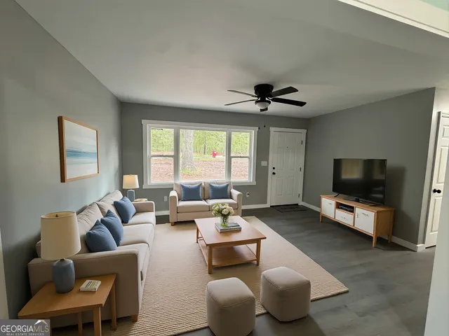 a living room with furniture and a flat screen tv