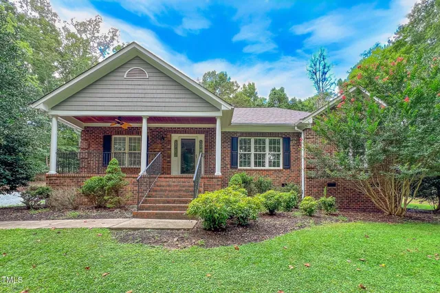 a front view of a house with a garden
