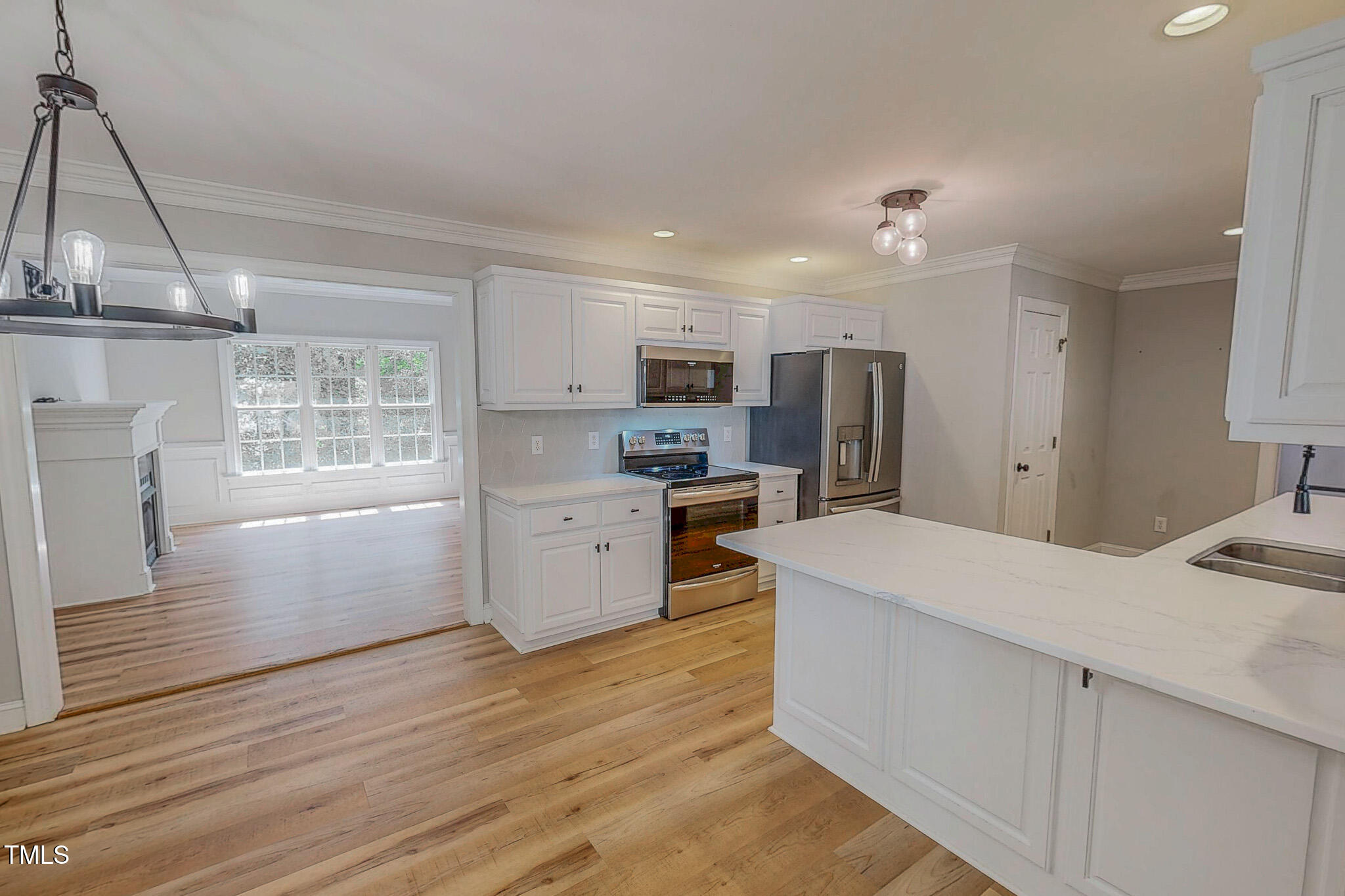 417 Rassie Crabtree Road Rougemont, NC 27572 - Photo 15 of 37 a open kitchen with kitchen island white cabinets and stainless steel appliances