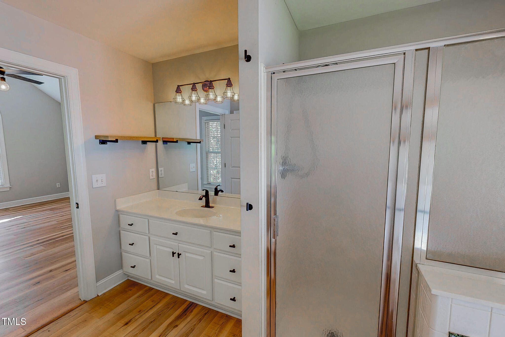 417 Rassie Crabtree Road Rougemont, NC 27572 - Photo 28 of 37 a bathroom with a sink a mirror and a shower