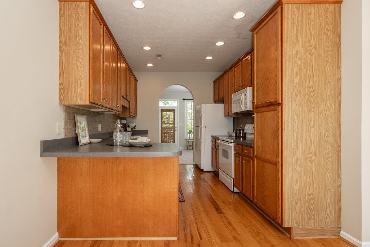 1398 Verdant Spring Lane Harrisonburg, VA 22801 - Photo 14 of 43 a kitchen with stainless steel appliances granite countertop a refrigerator a stove and a sink with wooden floor
