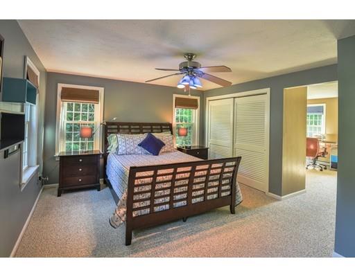 406 Sterling Road Holden, MA 01522 - Photo 15 of 42 a bedroom with a bed window and a flat tv screen