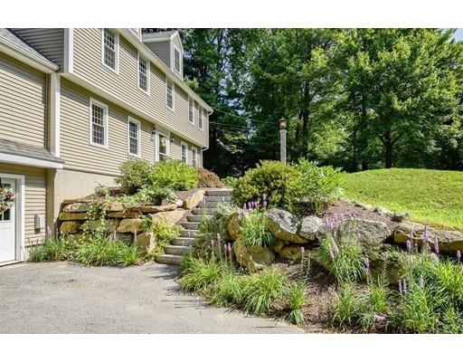 406 Sterling Road Holden, MA 01522 - Photo 41 of 42 a backyard of a house with a garden and plants