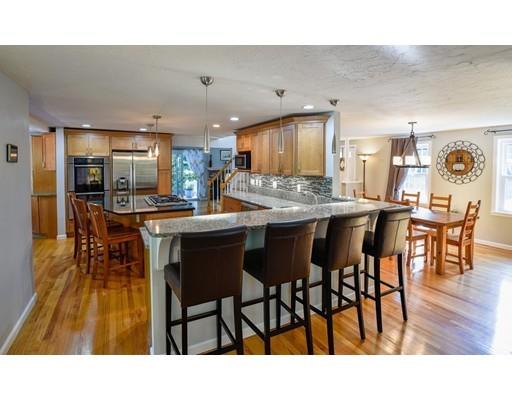 406 Sterling Road Holden, MA 01522 - Photo 5 of 42 a open kitchen with stainless steel appliances kitchen island granite countertop a dining table chairs and a oven