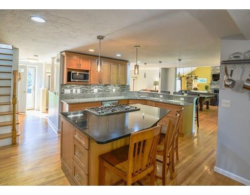 406 Sterling Road Holden, MA 01522 - Photo 6 of 42 a kitchen with stainless steel appliances granite countertop a sink a stove and a wooden cabinets