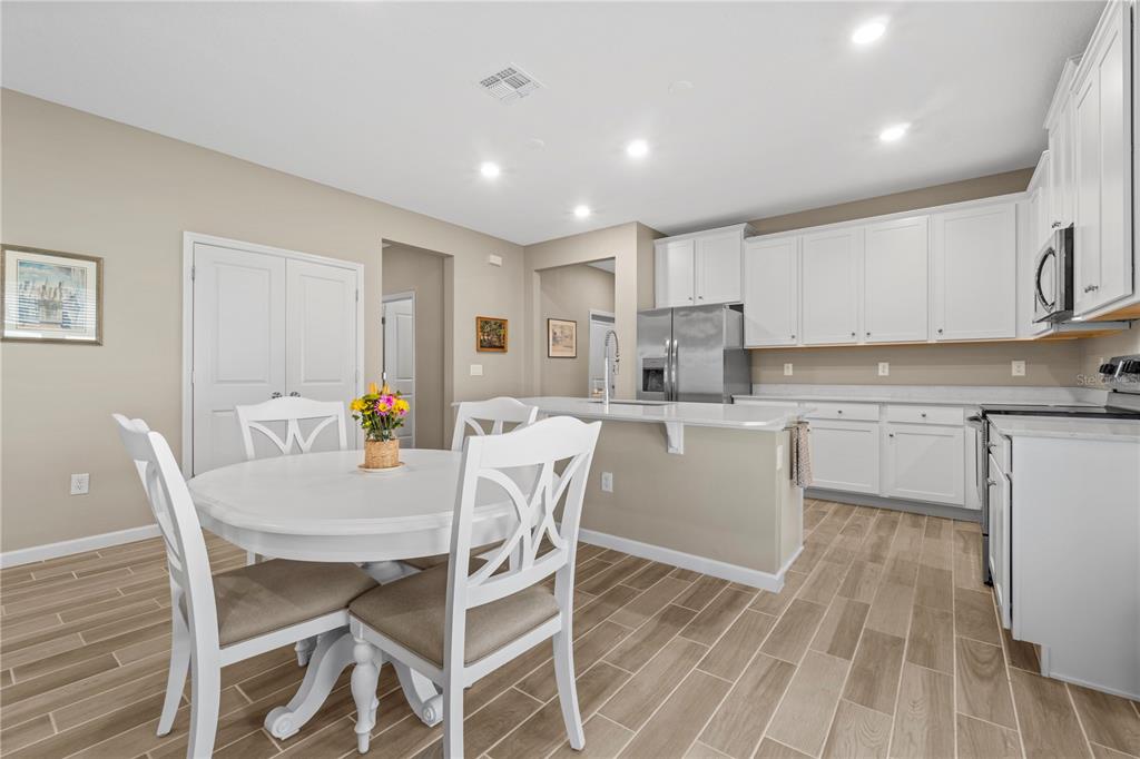 7381 Southwest 78th Terrace Ocala, FL 34474 - Photo 12 of 47 a view of kitchen with cabinets table and chairs