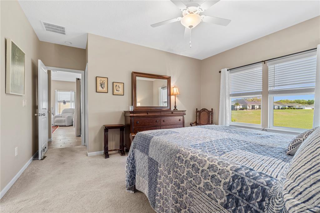 7381 Southwest 78th Terrace Ocala, FL 34474 - Photo 18 of 47 a bedroom with a bed and a chandelier