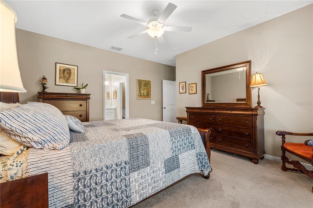 7381 Southwest 78th Terrace Ocala, FL 34474 - Photo 19 of 47 a bedroom with a bed and a dresser