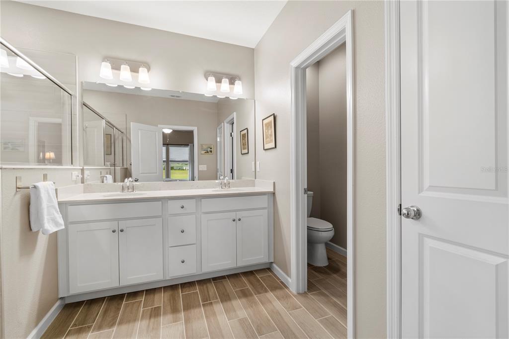 7381 Southwest 78th Terrace Ocala, FL 34474 - Photo 20 of 47 a spacious bathroom with a double vanity sink a mirror and a toilet