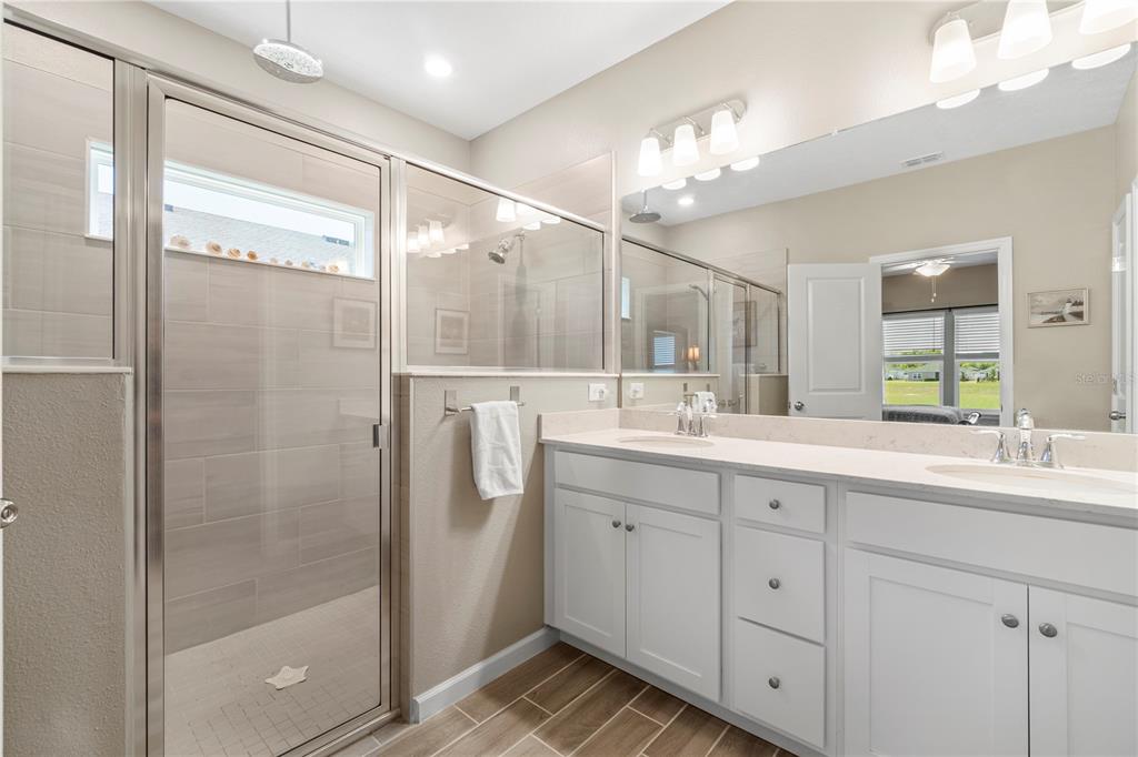 7381 Southwest 78th Terrace Ocala, FL 34474 - Photo 23 of 47 a bathroom with a double vanity sink mirror and shower