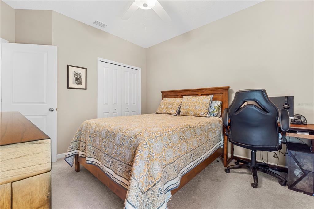 7381 Southwest 78th Terrace Ocala, FL 34474 - Photo 26 of 47 a bedroom with a bed and chair