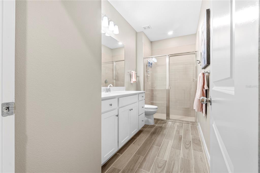 7381 Southwest 78th Terrace Ocala, FL 34474 - Photo 27 of 47 a bathroom with a double vanity sink toilet mirror and shower