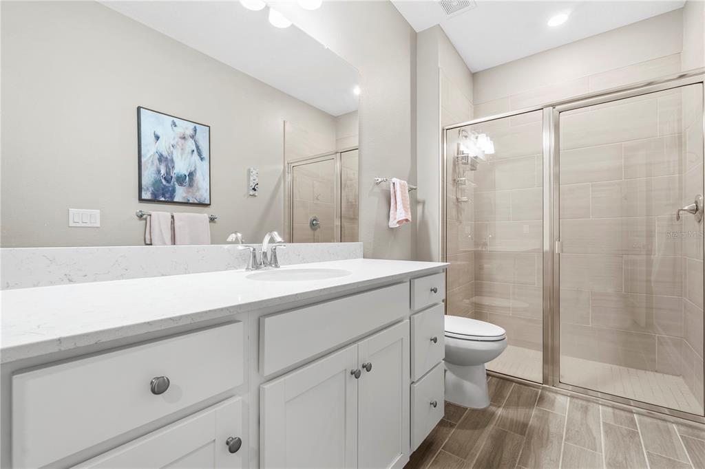 7381 Southwest 78th Terrace Ocala, FL 34474 - Photo 28 of 47 a bathroom with a double vanity sink toilet and shower