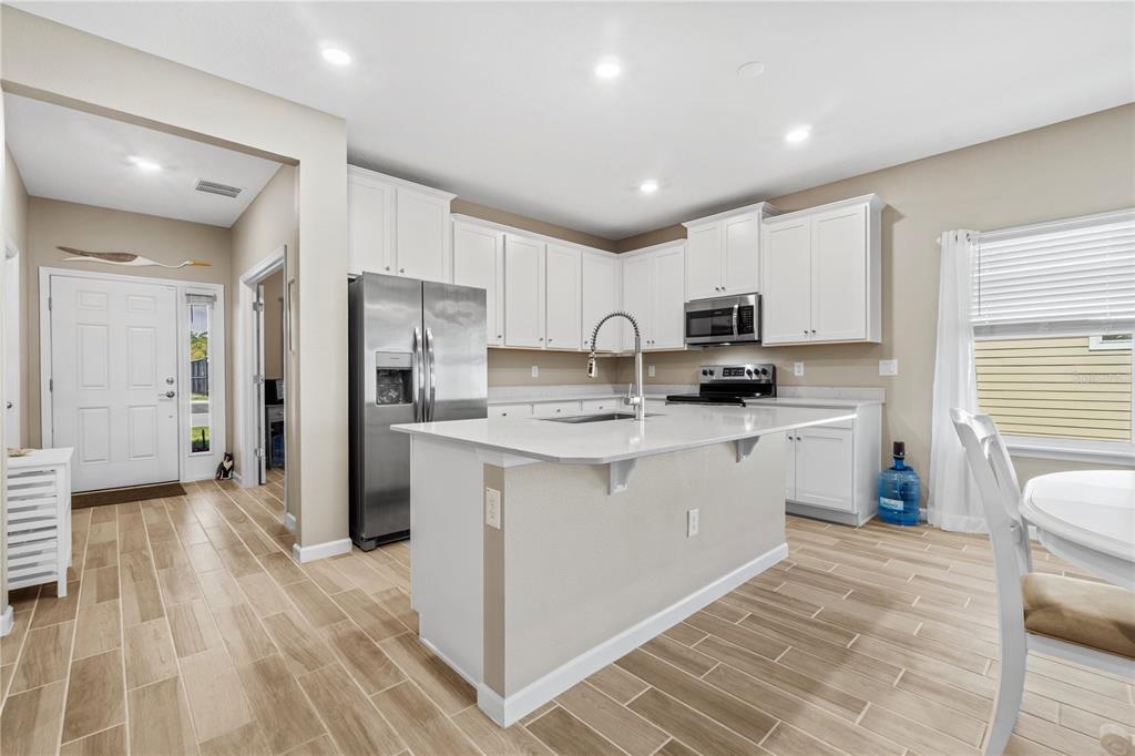 7381 Southwest 78th Terrace Ocala, FL 34474 - Photo 8 of 47 a kitchen with granite countertop a refrigerator stove top oven and sink