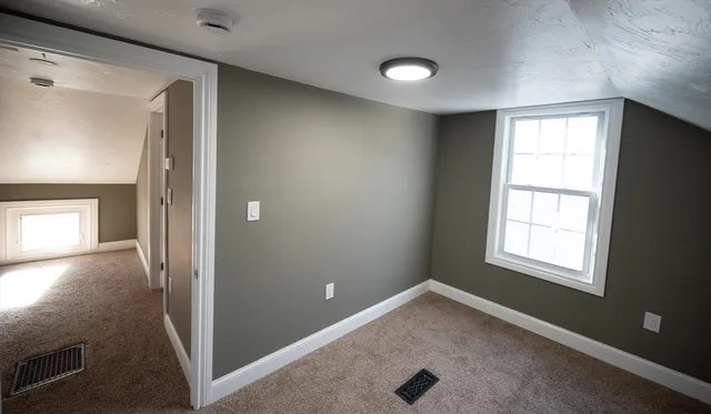 an empty room with windows and closet