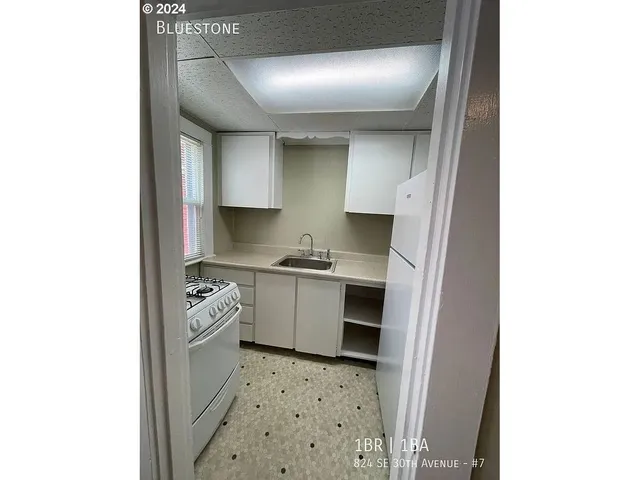 a kitchen with a sink stove and cabinets