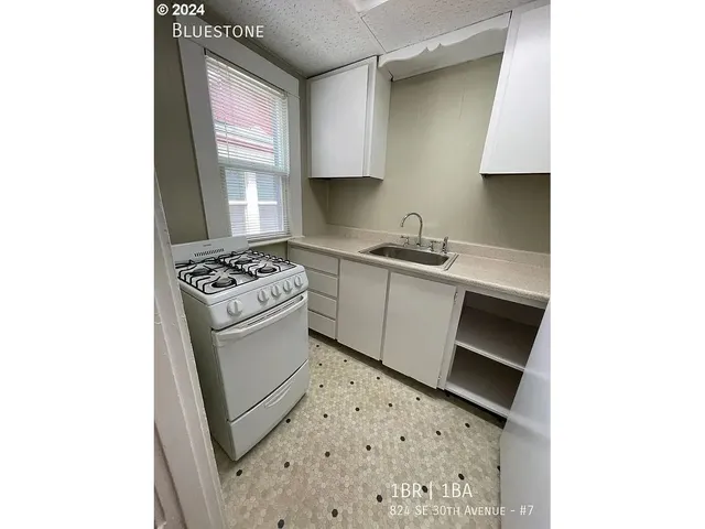 a kitchen with a refrigerator and a sink
