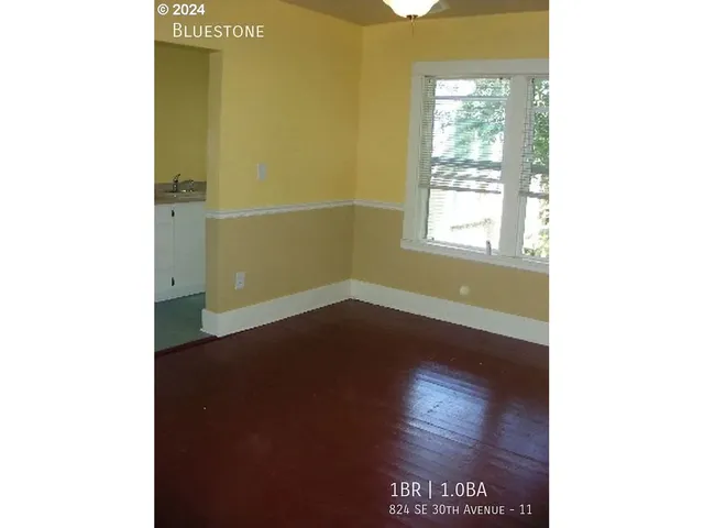 a kitchen with a refrigerator and a stove